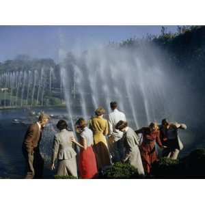  Visitors Duck as Wind Blows Spray from Water Fountains 