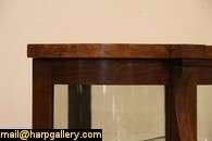 An American classic oak curved glass china or curio cabinet dates from 