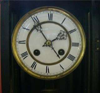   German made wall clock 8 day time strike . Ebonized . Fixer  