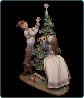   Trimming the tree Figurine #5897, Christmas tree & children figure