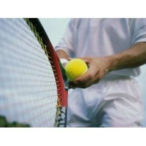  Man Holding a Tennis Ball and a Tennis Racket Photographic 